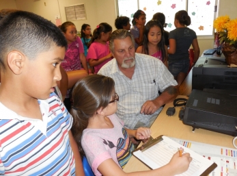 Students listen and wait for the chance to write down contact information.