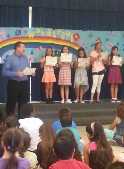 David presenting 4th grade Ham Radio Licensee certificates at year end awards assembly.